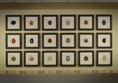 collection of geode cross-sections, framed in square frames and displayed as a grid